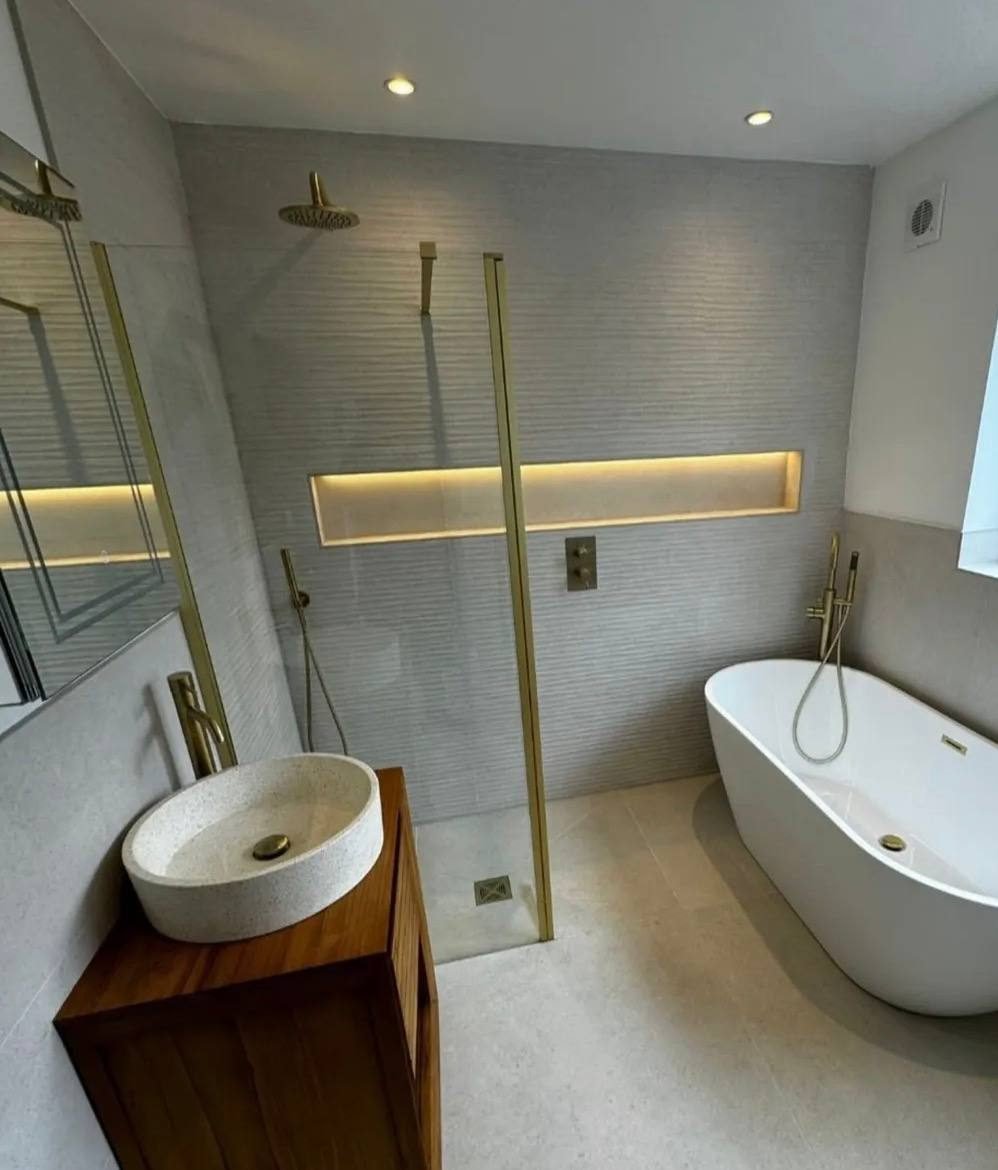Freestanding bath and walk-in shower with brushed brass tapware
